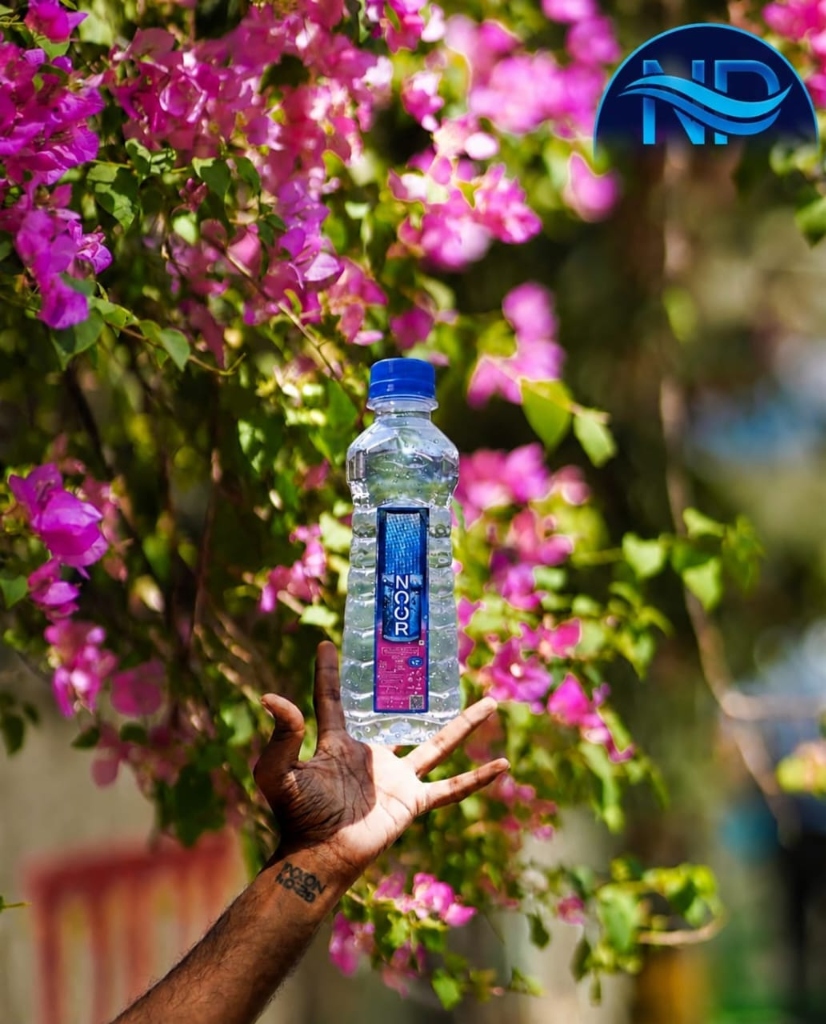 Noor Dhara Bottle with Floral Background